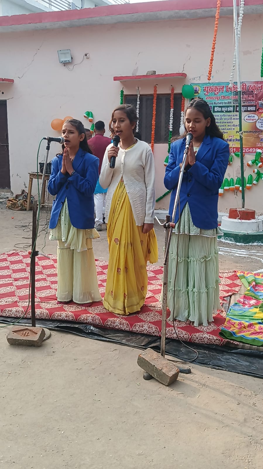 Students singing a patriotic song on stage at a school function